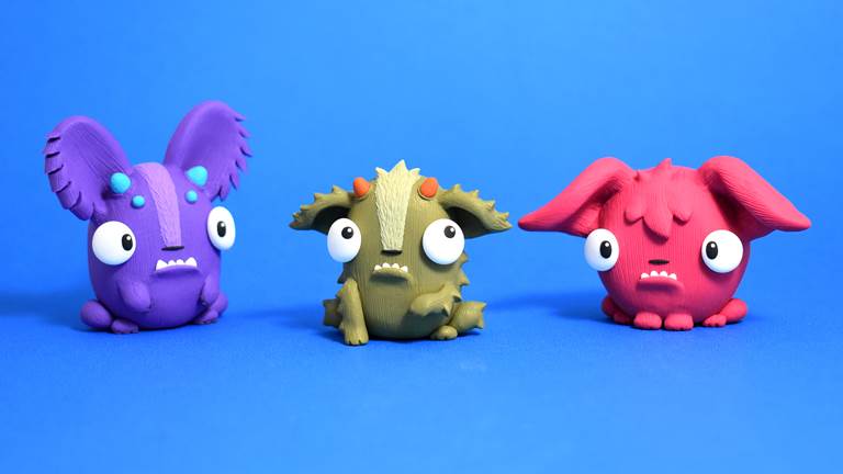 Three animal creatures made of polymer clay. 