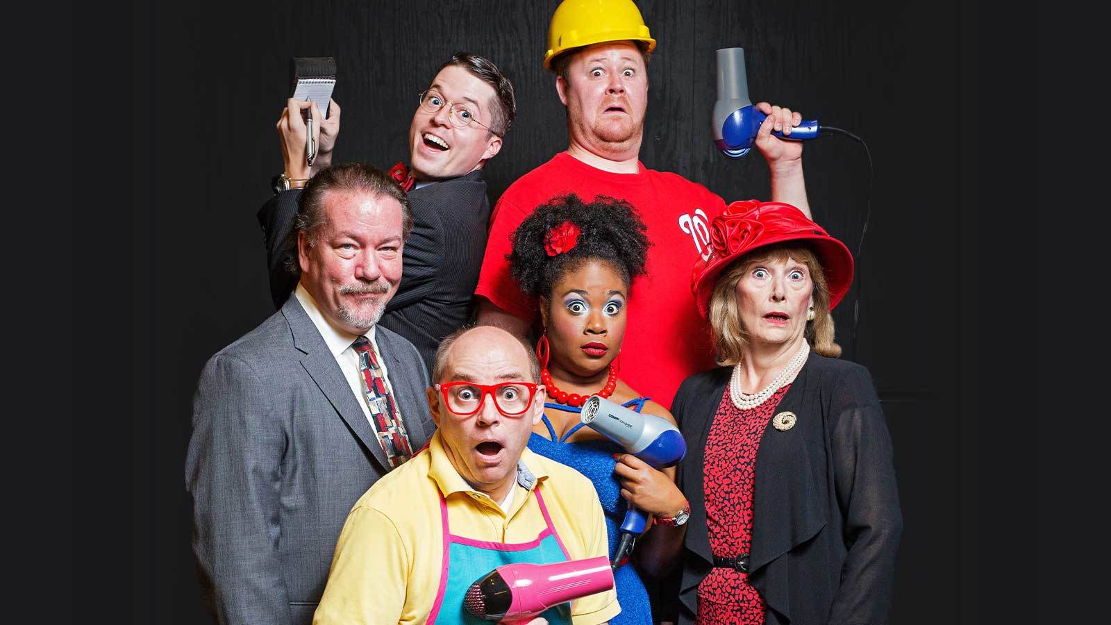 The six member cast of Shear Madness looks at the camera with funny expressions on their faces in character. Four are surprised, one is smirking, and one is eagerly smiling.
