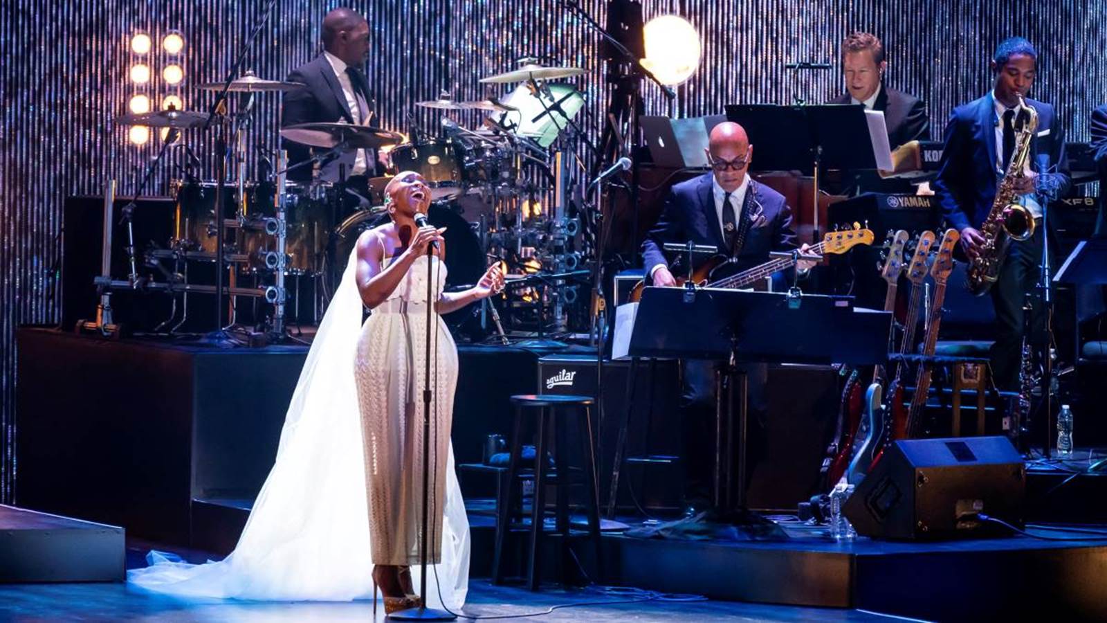 Cynthia Erivo sings on stage with a band.